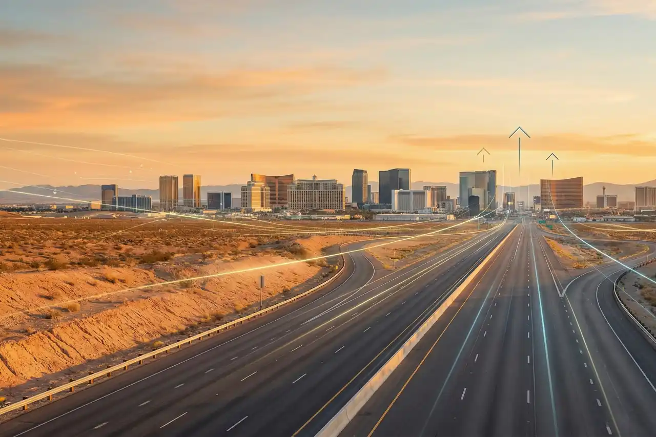 Las Vegas skyline at sunrise with a highway leading through the Nevada desert toward the city, symbolizing international business expansion and entry into the U.S. market.